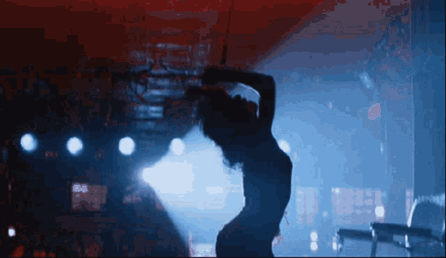 a silhouette of a woman in a dark room