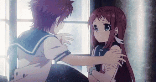 a boy and a girl are hugging each other in front of a window in a room .