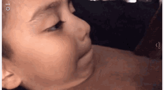 a close up of a baby 's face looking at something .