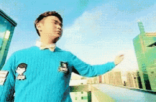 a man wearing a blue sweater with a snoopy patch on it