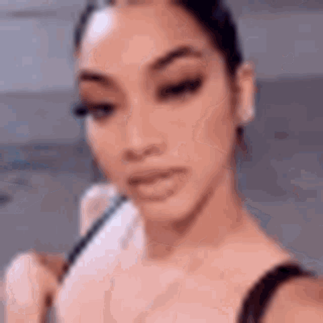 a close up of a woman taking a selfie with a blurred background .