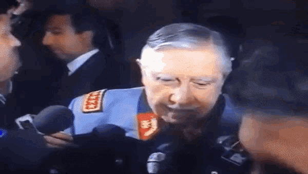 a man in a blue uniform is talking into a microphone with the words vi ska gora sverige lagom igen below him