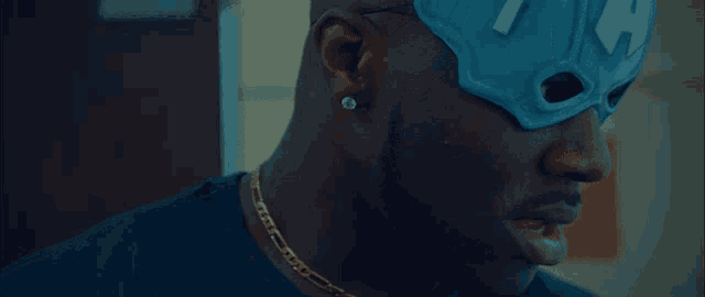 a man wearing a blue mask that says ya on it