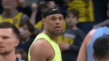 a basketball player wearing a headband and a neon green shirt