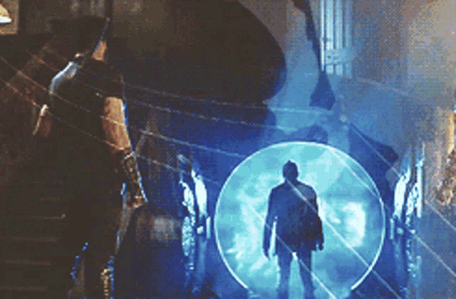 a man in a suit is standing in front of a blue circle