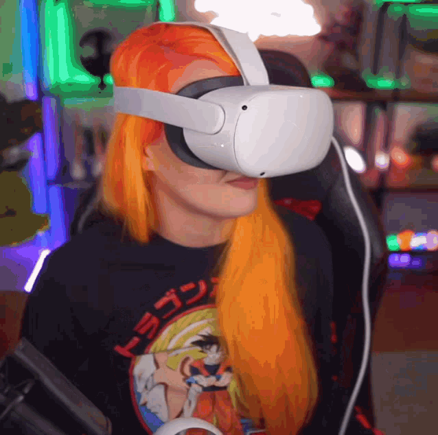 a woman wearing a virtual reality headset with a dragon ball z shirt on