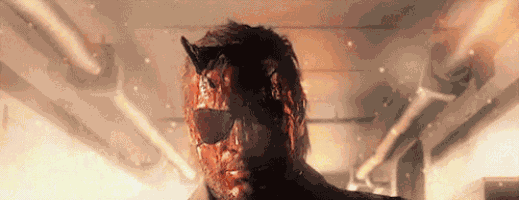 a man with blood on his face is wearing sunglasses and a mask .