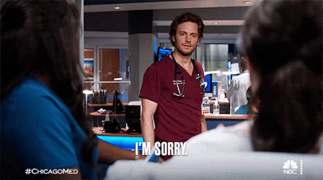 a man with a stethoscope around his neck says i 'm sorry in a hospital