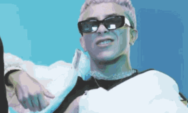 a man with pink hair is wearing sunglasses and a black jacket