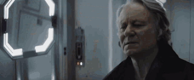 a close up of an older man 's face in front of a door