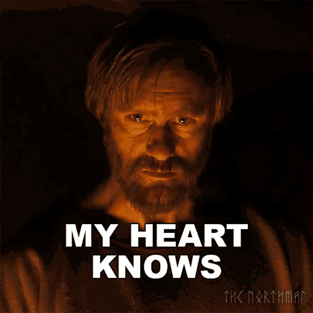 a man with a beard says " my heart knows " in front of him