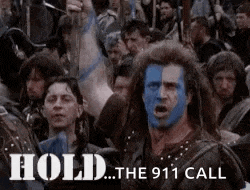 a man with blue paint on his face is in a crowd of people .