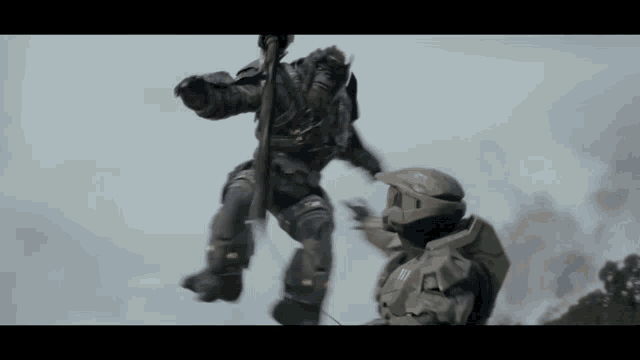 a man in a halo helmet is standing next to another man in a halo helmet