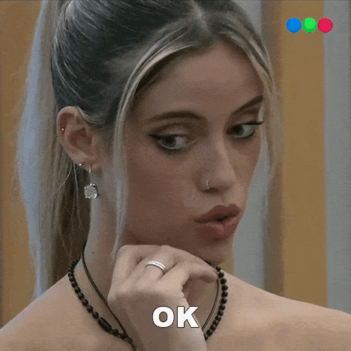 a close up of a woman 's face with the word ok above her