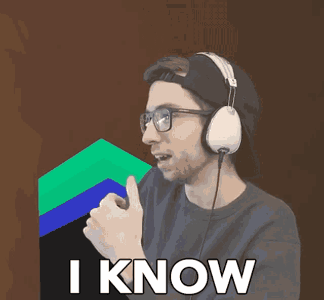 a man wearing headphones and glasses is giving a thumbs up and says i know