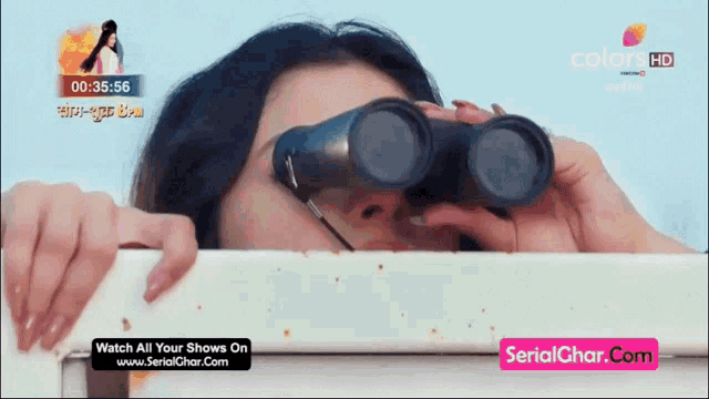 a woman looking through binoculars on a screen that says colors hd
