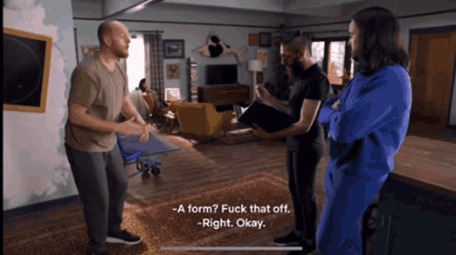 a group of people are standing in a living room and one of them is saying " a form "