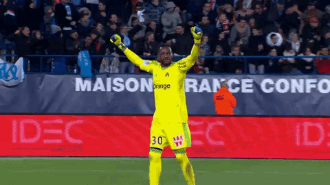 a soccer player wearing a yellow jersey with the number 30