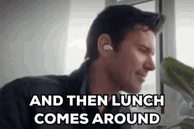 a man wearing headphones is sitting in front of a window with the words `` and then lunch comes around '' written below him .
