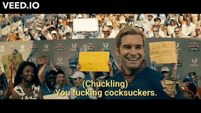 a man holding a sign that says " chuckling " in front of a crowd of people