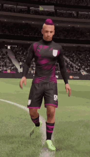 a soccer player with a pink mohawk and number 9 on his shorts