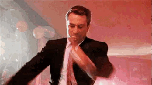 a man in a suit and tie is dancing
