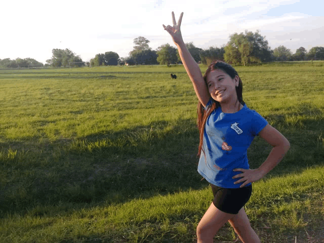 a girl wearing a blue shirt that says ' i love you ' on the front