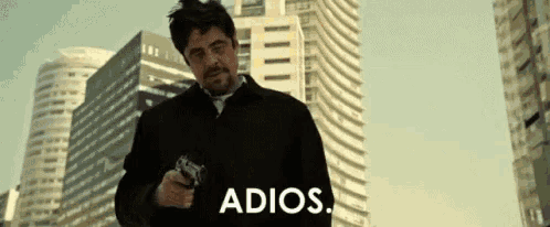a man holding a gun says adios in front of a city