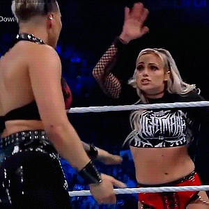 two women are in a wrestling ring and one is wearing a shirt that says nightmares