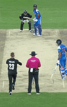 a man wearing a phillips 23 jersey is running towards a cricket player