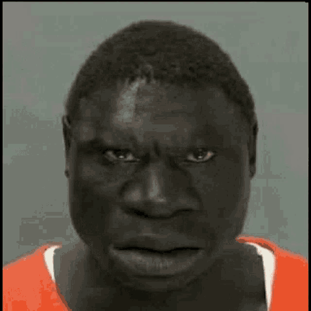 a close up of a man 's face with a very angry look on his face .