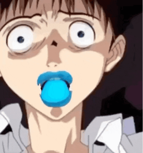 a close up of a person 's face with a blue bubble in their mouth .