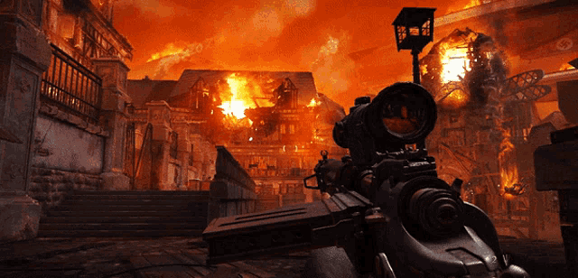 a sniper rifle is pointed at a burning building in a video game