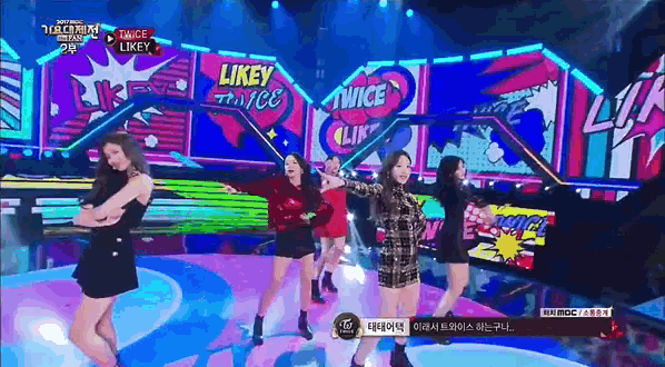 a group of girls are performing on a stage with a sign that says likey twice