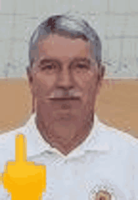 a man in a white shirt is giving a thumbs up .