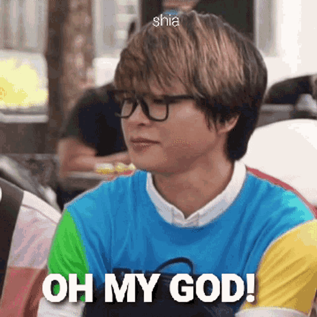 a young man wearing glasses and a colorful shirt is saying oh my god