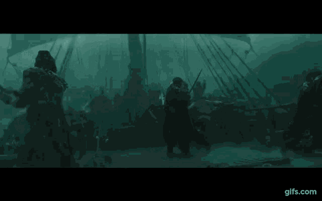 a group of people are standing on the deck of a boat in the water .