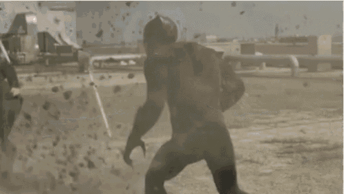 a black panther is standing on a rooftop in the desert .