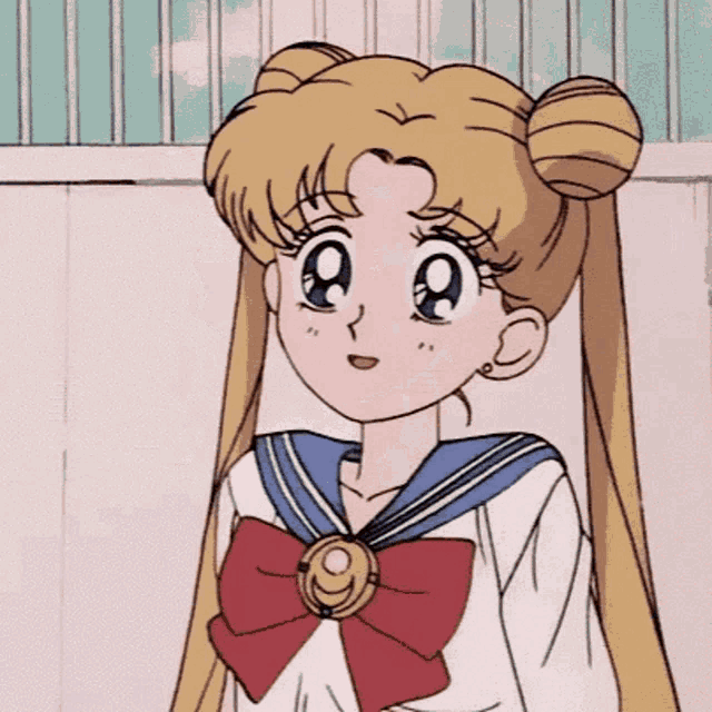 a girl in a sailor suit with a red bow on her neck .