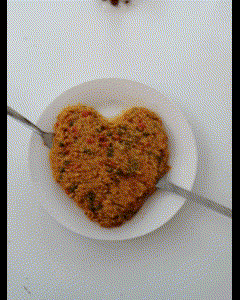 a heart shaped plate of food with a fork on it