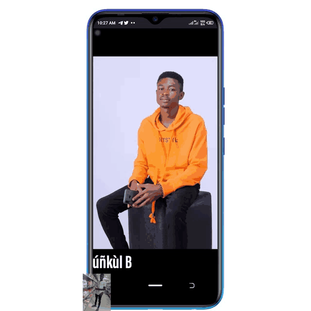 a phone shows a picture of a young man in an orange hoodie