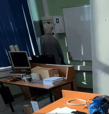 a man standing in front of a white board with a sticker on it that says ' epson ' on it