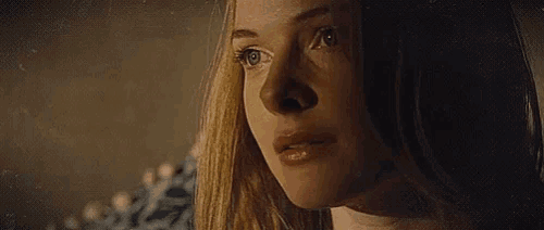 a close up of a woman 's face with tears running down her face .