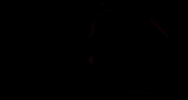 a monster with a gas mask on is standing in the dark .