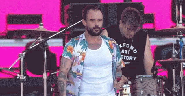 a man wearing a shirt that says okford art factory