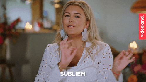 a woman in a white shirt has the word sublim on the bottom right