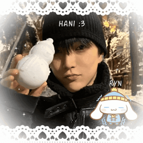 a boy wearing a black hat with hani 3 on it