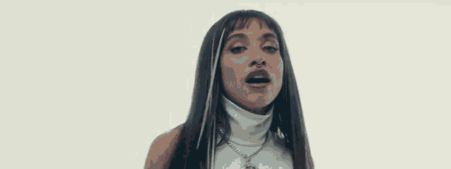 a close up of a woman 's face with long hair and a white turtleneck