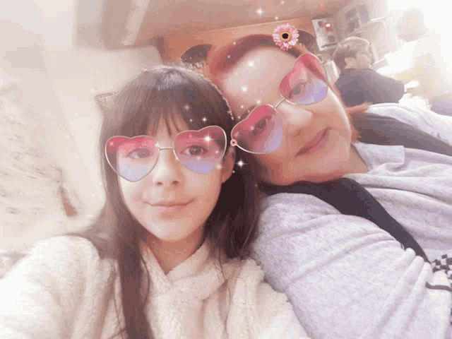 a woman and a little girl wearing heart shaped sunglasses