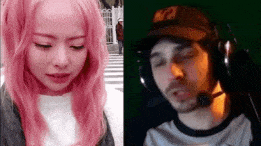 a woman with pink hair is crying next to a man with headphones on .